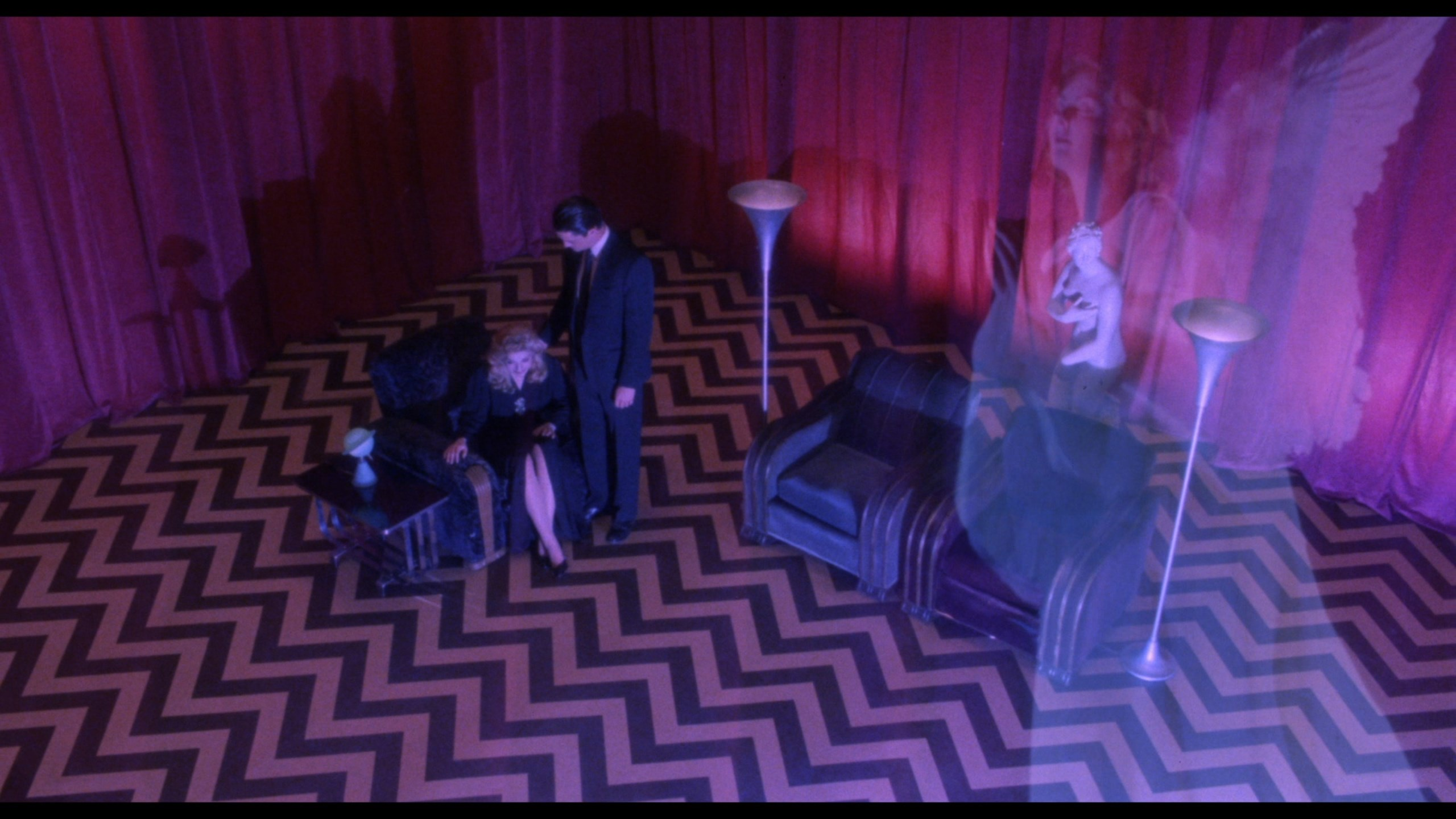 The final shot of Twin Peaks: Fire Walk with Me, where Cooper consoles a sobbing Laura Palmer inside the red room, with an image depicting her as an angel overlaid onto the scene.